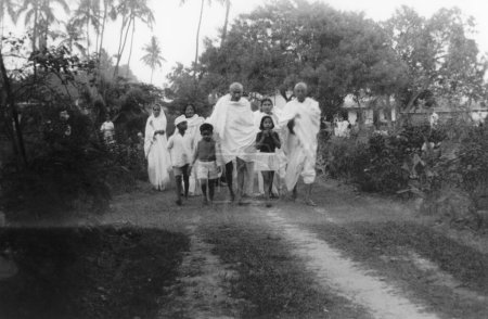 Photo for Mahatma Gandhi and others walking at Khadi Pratishthan ; Sodepur ; 24 Parganas ; Calcutta ; 1946  ; India - Royalty Free Image