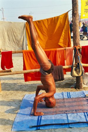 Photo for Man doing yoga, kumbh fair, Allahabad, Uttar Pradesh, India, 2000 - Royalty Free Image