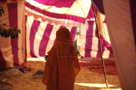Photo for Sikh woman devotee with her head covered standing in tent near Sachkhand Saheb Gurudwara in Nanded, Maharashtra, India - Royalty Free Image