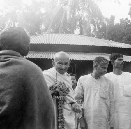Photo for Mahatma Gandhi and others during his tour to Bengal at Malikanda Gandhi Seva Sangh, 1940, India - Royalty Free Image