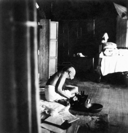 Photo for Mahatma Gandhi. spinning inside a building at Chaumuhani Noakhali East Bengal. 20th November 1946. India - Royalty Free Image