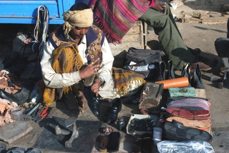 Photo for Shoemaker doing polish to shoe, Jaisalmer, Rajasthan, India - Royalty Free Image