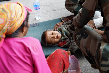 Photo for Army medical personnel treat child injured, nepal, asia - Royalty Free Image