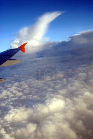 Aerial view of clouds and aircraft wing 