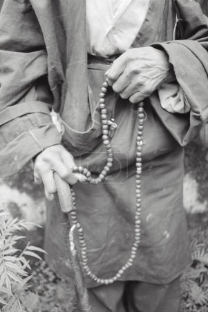Téléchargez les photos : Homme bouddhiste chantant sur des perles, Darjeeling, Bengale occidental, Inde - en image libre de droit