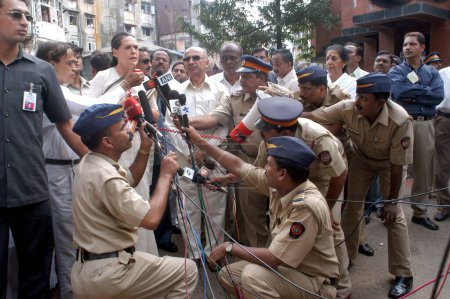 Téléchargez les photos : La présidente du Congrès, Sonia Gandhi, s'est entretenue avec des policiers des médias qui tenaient un micro sur le site de l'explosion d'une bombe à Zaveri Bazaar dans la zone occupée de Kalbadevi, Bombay Mumbai, Maharashtra, Inde Le 26 août 2003 - en image libre de droit