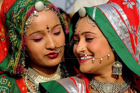 Téléchargez les photos : Filles en bijoux traditionnels et costume rajasthani bavarder entre elles, Foire de Pushkar, Rajasthan, Inde - en image libre de droit