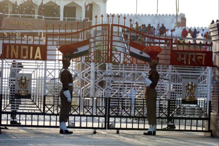 Photo for Indian Border Security Force soldiers during evening retreat ceremony called lowering flags at India-Pakistan international Border ; Wagah border ; Attari ; Punjab ; India - Royalty Free Image