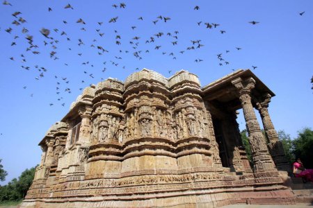 Photo for Pigeons have flights over the top of the Modhera Sun temple (1026 A.D.) situated at a distance of 102 kms from Ahmedabad on the bank of the river Pushpavati ; Gujarat ; India - Royalty Free Image