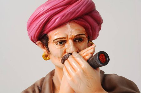 Foto de Clay figurine , statue of rajasthani man smoking chillum - Imagen libre de derechos