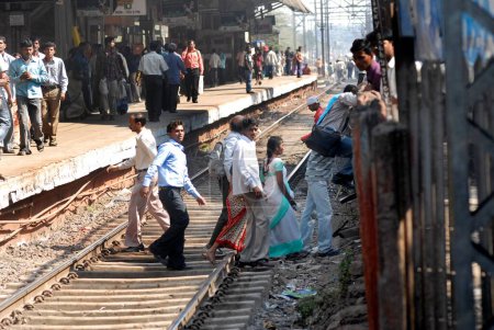 Photo for Commuter dangerously crossing railway tracks in Bombay Mumbai ; Maharashtra ; India - Royalty Free Image