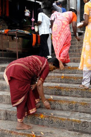 Photo for Women devotees burning camphor on each steps, Tirutani, Tamil Nadu, India - Royalty Free Image
