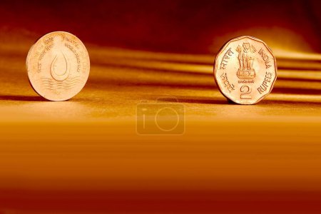 Photo for Double pair Indian currency two rupees coin front side and backside manner embossed water for life world food day 1994 on orange background - Royalty Free Image
