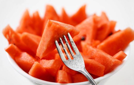 Photo for Fruits , Water Melon Latin Citrullus Lanatus cut pieces in bowl with fork - Royalty Free Image