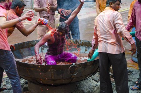 Téléchargez les photos : Les gens versent de l'eau avec de la couleur dans le festival Holi Jodhpur au Rajasthan Inde - en image libre de droit