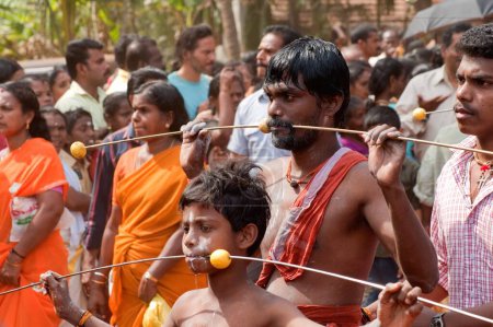 Photo for Pierced devotees spike through cheeks discharging vow in Thaipusam festival, Kerala, India - Royalty Free Image