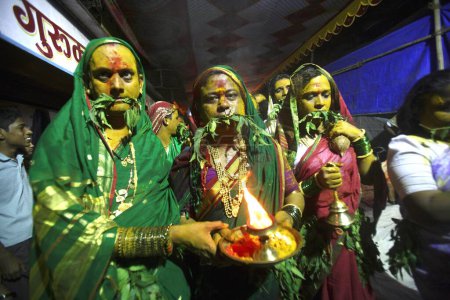 Photo for Eunuch followers with tugged neem leaves praying before goddess Yellama ; wedding of eunuchs on occasion of Bewa Purnima at Ghatkopar ; Bombay now Mumbai ; Maharashtra ; India - Royalty Free Image