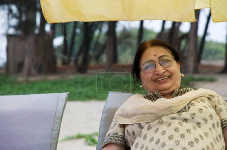 Photo for Lady resting at Vayangani beach at Sindhudurgh, Maharashtra, India - Royalty Free Image