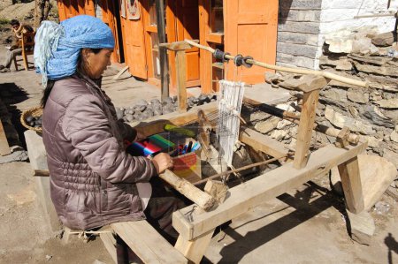 Photo for Woman weaving woollen on handloom, Muktinath, Nepal - Royalty Free Image