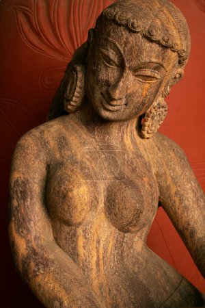 Photo for Indian heritage art in form of sculpture of woman in nude wearing big earrings and styled hair with curves of body very beautifully crafted ; Pune ; Maharashtra ; India - Royalty Free Image