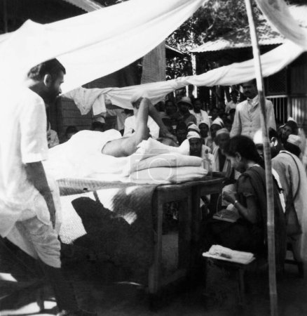 Photo for Mahatma Gandhi talking people while taking sunbath village Dasgharia Noakhali East Bengal Kanu Gandhi stayed from November - Royalty Free Image