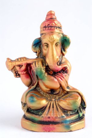 Colourful statue of lord Ganesha elephant headed god playing shehnai flute , India