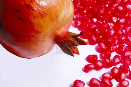 Photo for Fruits , one full Pomegranate and seeds on white background - Royalty Free Image