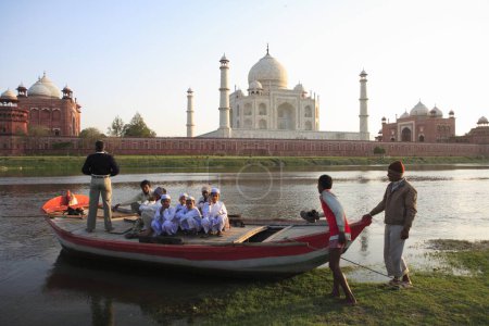 Photo for Villagers in boat in river Yamuna at Taj Mahal Seventh Wonders of World , Agra , Uttar Pradesh , India UNESCO World Heritage Site - Royalty Free Image