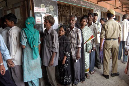 Photo for People standing in queue to vote during the 2004 Indian Loksabha elections at polling booth at Shivaji Nagar, Govandi, Mumbai Bombay  Maharashtra, India - Royalty Free Image