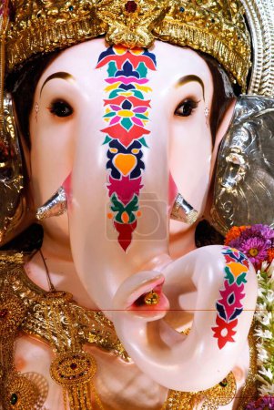 Close up of richly decorated idol of Lord Ganesh elephant headed god ; Ganapati festival at Pune ; Maharashtra ; India