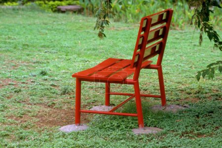 Photo for Red wooden bench in garden - Royalty Free Image