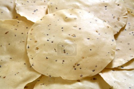 Raw papad poppadom made of various lentil or cereal flours