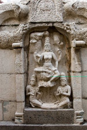 Goddess Saraswati  wisdom & learning statue on parapet wall back of temple Vimana in Sundaravarada Perumal temple built in Pallava period eight century in Uttiramerur ; Tamil Nadu ; India