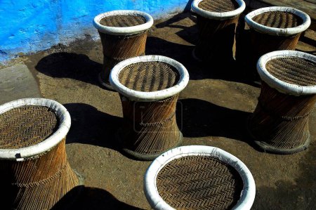 Photo for Wooden cane chairs against blue textured wall , pushkar , Rajasthan , Rajasthan , India - Royalty Free Image