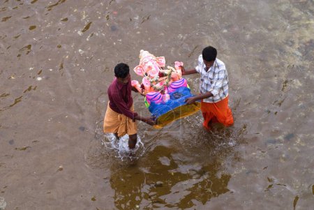 Téléchargez les photos : Personnes portant l'idole de lord ganesh pour l'immersion dans la rivière bhavani sur le festival ganpati ; Dharapuram ; Tamil Nadu ; Inde 2009 - en image libre de droit