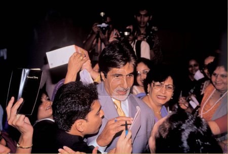 Photo for South Asian Indian Bollywood actor Amitabh Bachchan surrounded by his fans at a function at Oberoi hotels, Bombay Mumbai, Maharashtra, India - Royalty Free Image