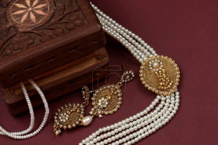 Vintage wooden jewellery box with Indian traditional jewelry, pearl earrings, pearl bracelet Luxury female jewelry, Indian traditional jewellery, Bridal Gold wedding jewellery, pearl jewelry
