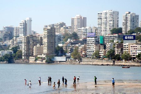 Photo for Tourist enjoying sea water at walkeshwar, Bombay, Mumbai, Maharashtra, India - Royalty Free Image