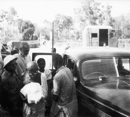 Photo for Mahatma Gandhi, accompanied by Khan Abdul Gaffar Khan, leaving a car in Bihar, 1947, India - Royalty Free Image