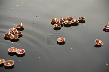 Photo for Oil lamp floating on river, mathura, uttar pradesh, india, asia - Royalty Free Image