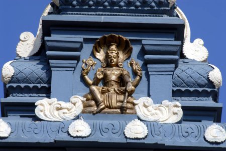 Photo for Lord Vishnu sitting on coiled serpent Shesha at Richly decorated , colorful facade of the Udupi Sri Krishna Temple Karnataka - Royalty Free Image