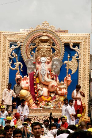 Photo for Huge idol of lord Ganesh ganpati elephant headed god being paraded in immersion ; Pune; Maharashtra ; India - Royalty Free Image