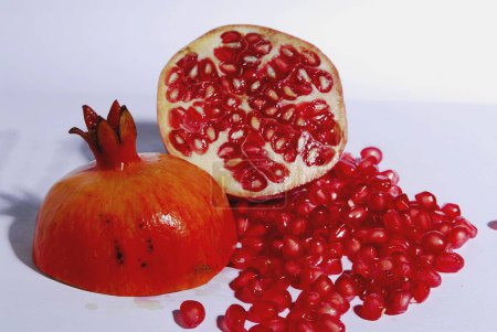 Photo for Fruits , one cut Pomegranate with seeds on white background - Royalty Free Image