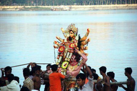 Photo for Devotees immersing Durga model in river - Royalty Free Image