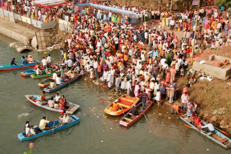 Photo for People thronging at Mula river side for immersion of idol of lord Ganesh ganpati elephant headed god on tenth day of festival ; Pune ; Maharashtra ; India - Royalty Free Image
