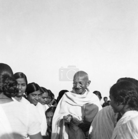 Photo for Mahatma Gandhi, surrounded by women of Mahila Ashram Wardha at Sevagram Ashram, 1945, Dr. Sundaram wife of G. Ramachandran, founder of Gandhigram near Madurai, India - Royalty Free Image