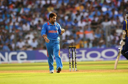 Téléchargez les photos : Le joueur indien Sachin Tendulkar réagit lors de son passage au bowling lors de la finale de la Coupe du monde de cricket ICC contre le Sri Lanka au stade Wankhede à Mumbai en Inde le 02 avril 2011 - en image libre de droit