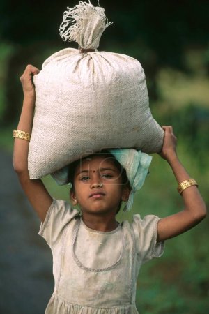 Photo for Girl holding jute bag on head - Royalty Free Image