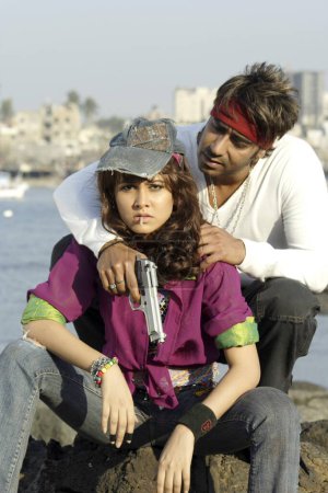 Photo for Bollywood film actor Ajay Devgan and Nisha Kothari in movie Ram Gopal Varma ki Aag - Royalty Free Image
