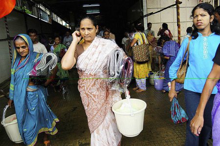 Photo for Local poor residents get relief materials in Ghatkopar, Bombay Mumbai, Maharashtra, India 26 July 2005 - Royalty Free Image